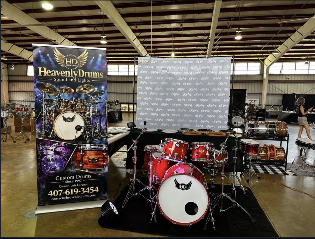 Heavenly Drums booth with a red custom drum kit at the Florida Drum Fest