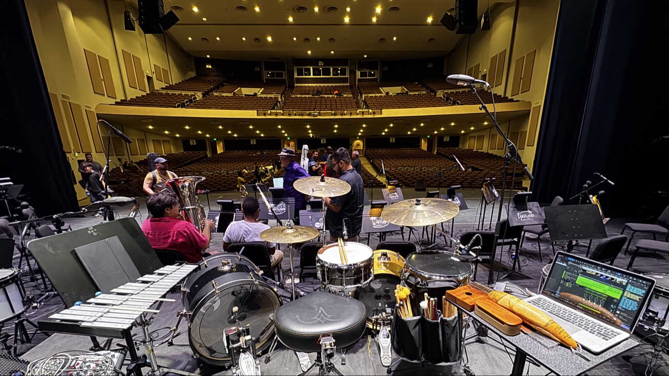 Emanuel Lozada performing on drums with an orchestra